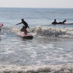 group of young surfers learning to surf