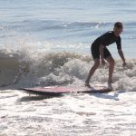 teen surfing by himself